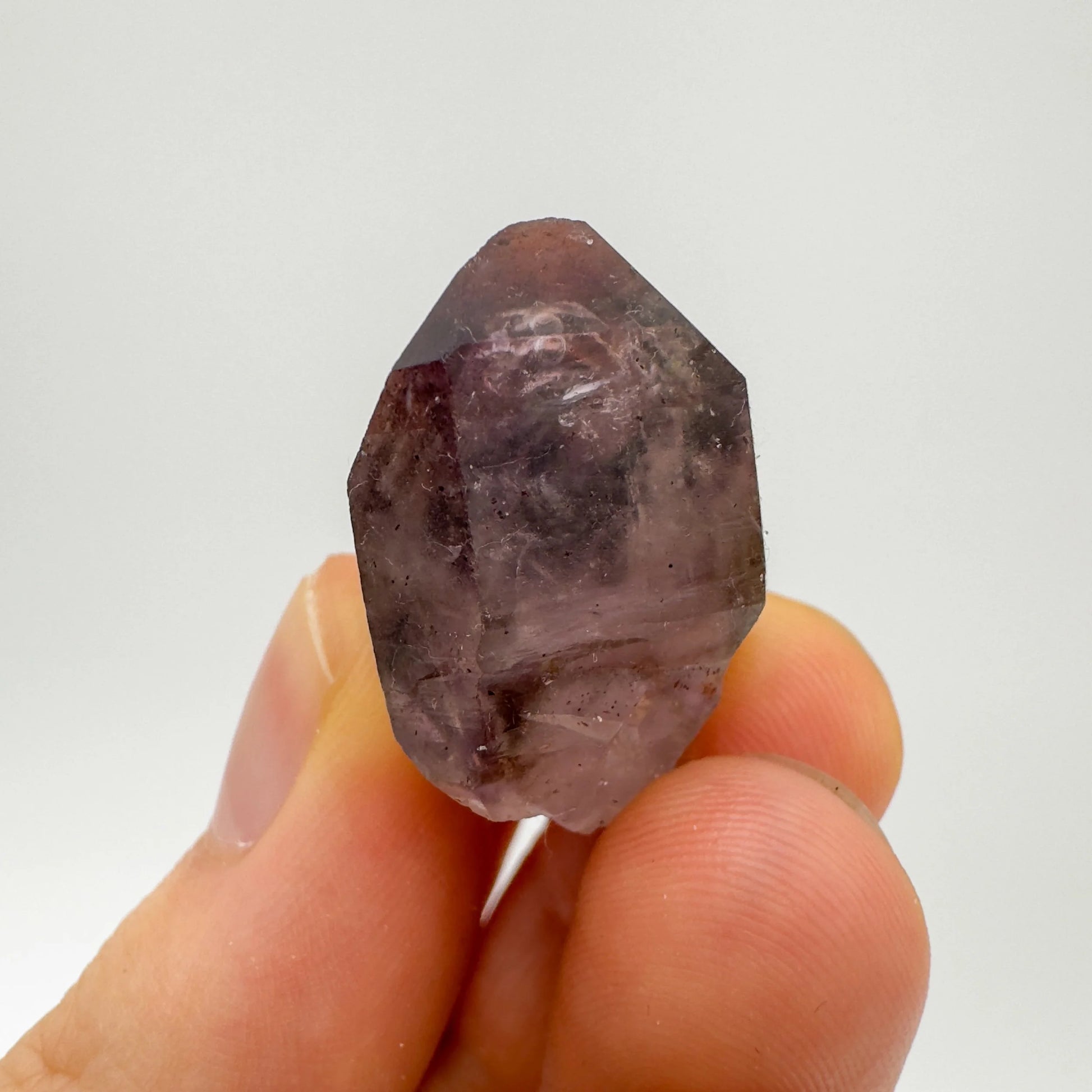 Detail shot of Grade A Smoky Amethyst point under natural light