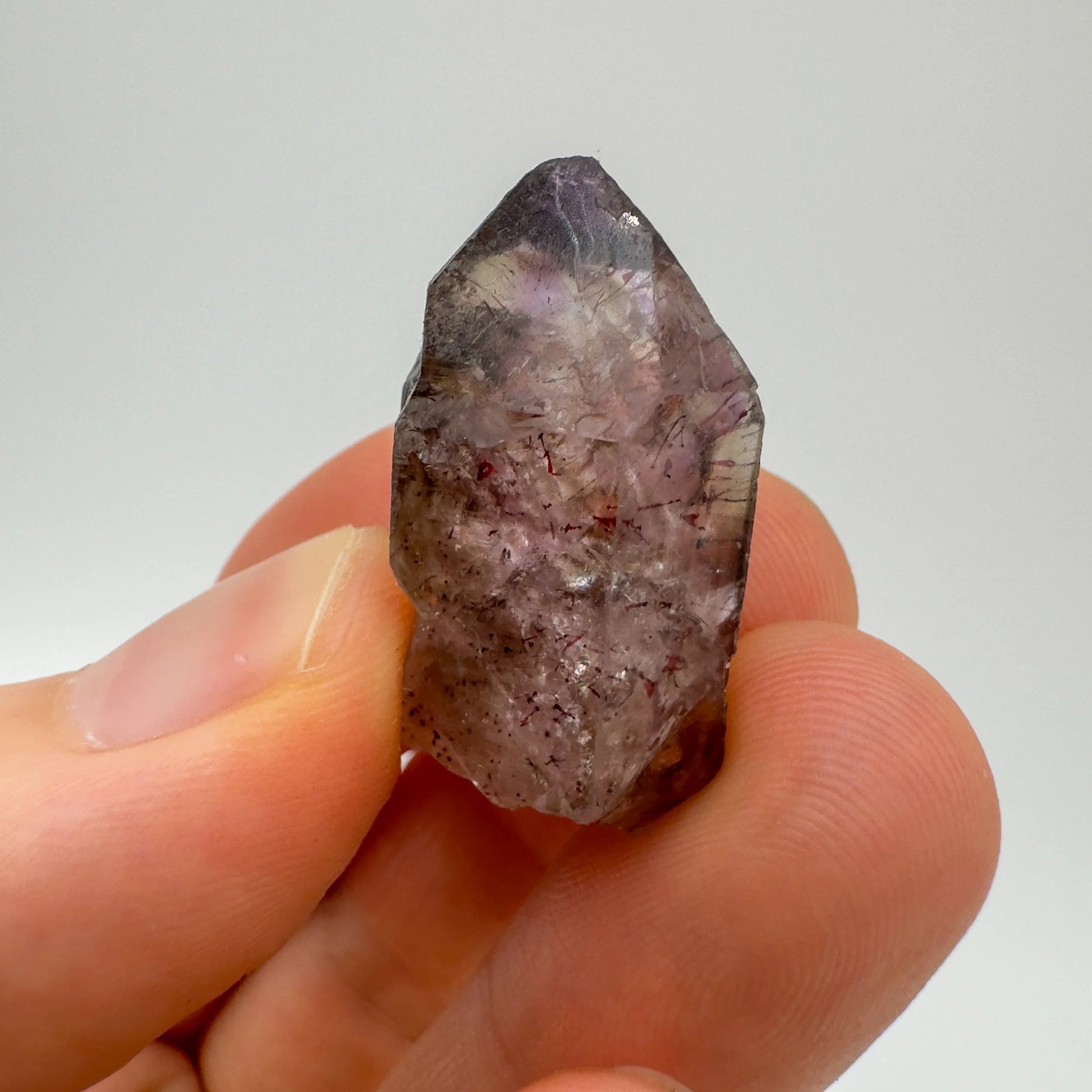 Soft-light view of Smoky Amethyst raw crystal, set to give a sense of weight.