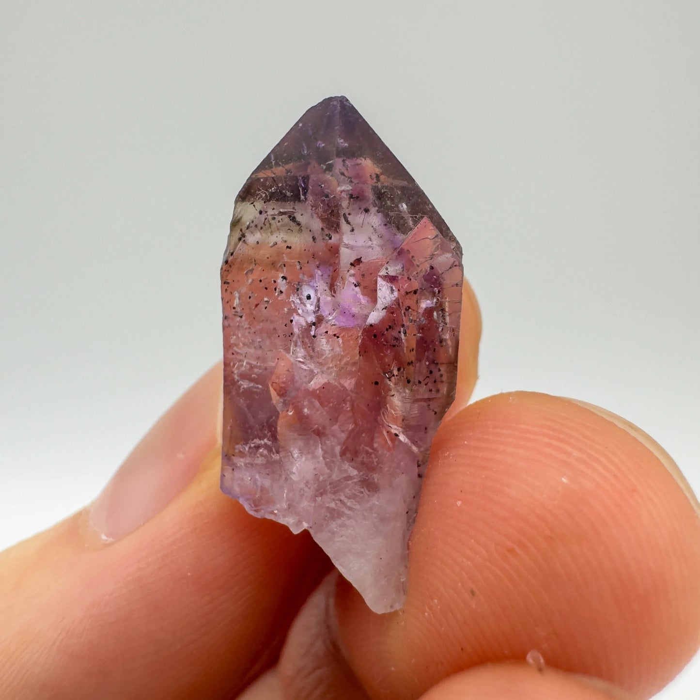 Detail shot of Grade A Smoky Amethyst point under natural light