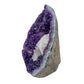 AA grade amethyst geode from Uruguay, angled three-quarter view, a grey and tan agate shell, specimen 53.