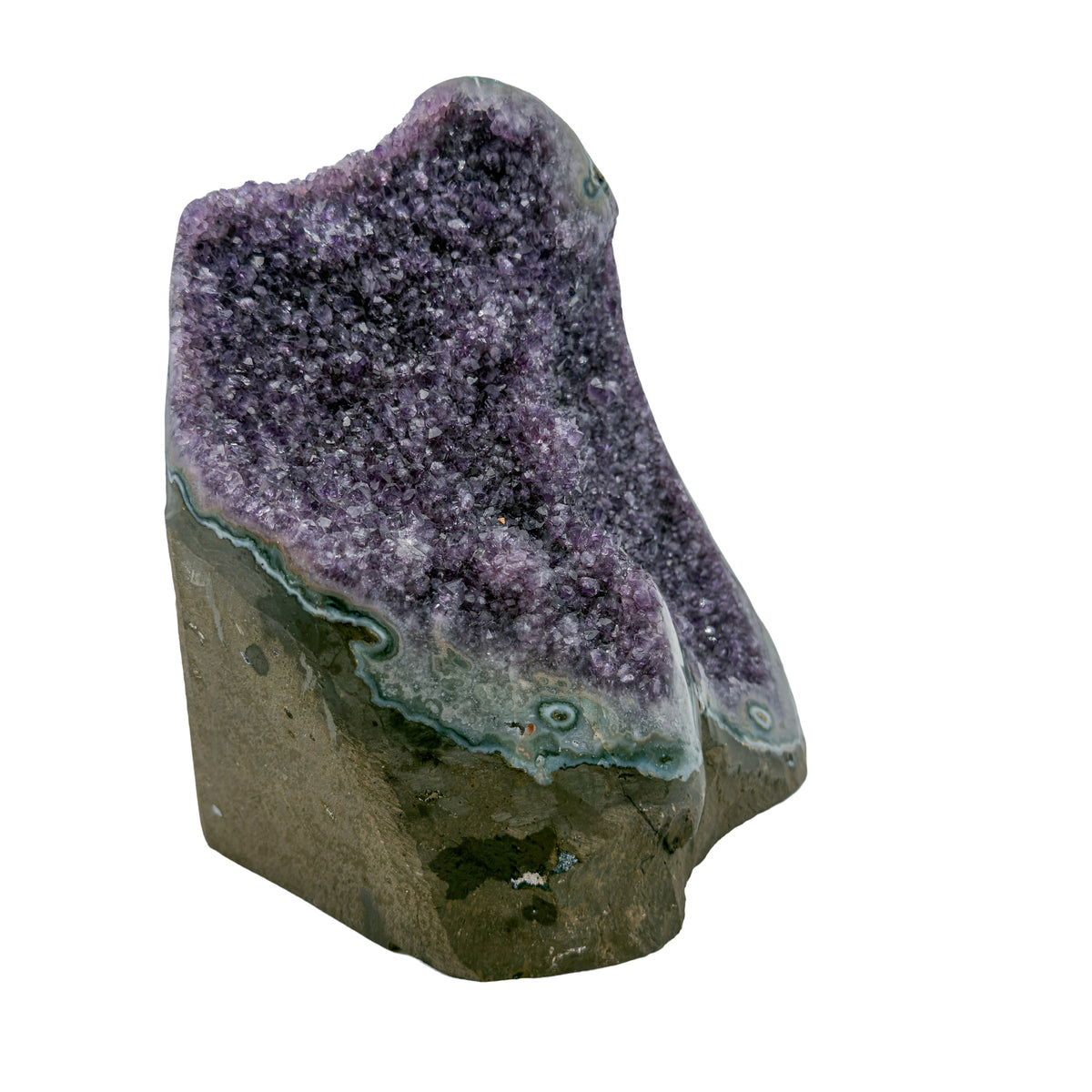 AA grade amethyst geode from Uruguay, left profile, a thick olive-brown basalt base with teal celadonite banding, specimen 41.