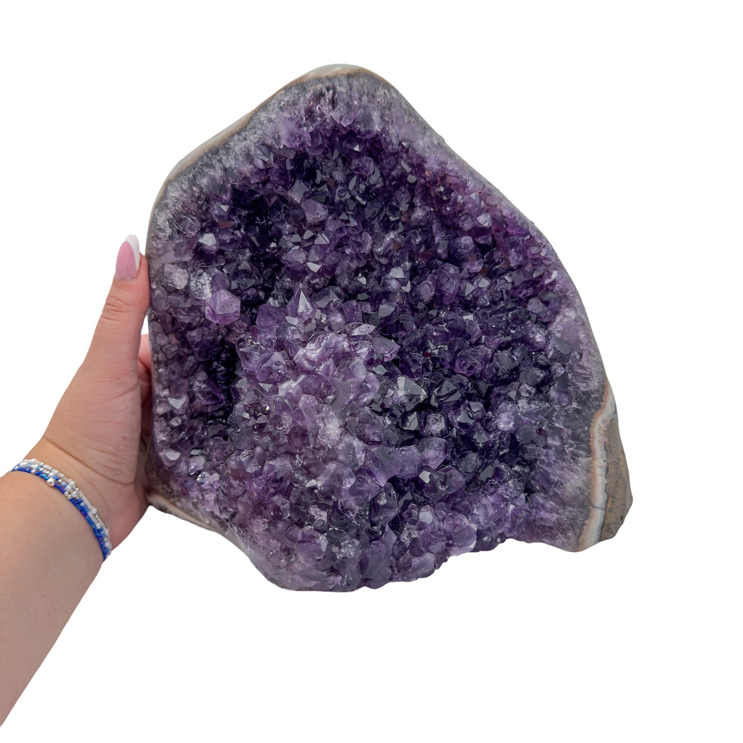 Amethyst polished geode from Uruguay held in an open hand, showing true scale, 10.93 pound broad upright geode, specimen 55.