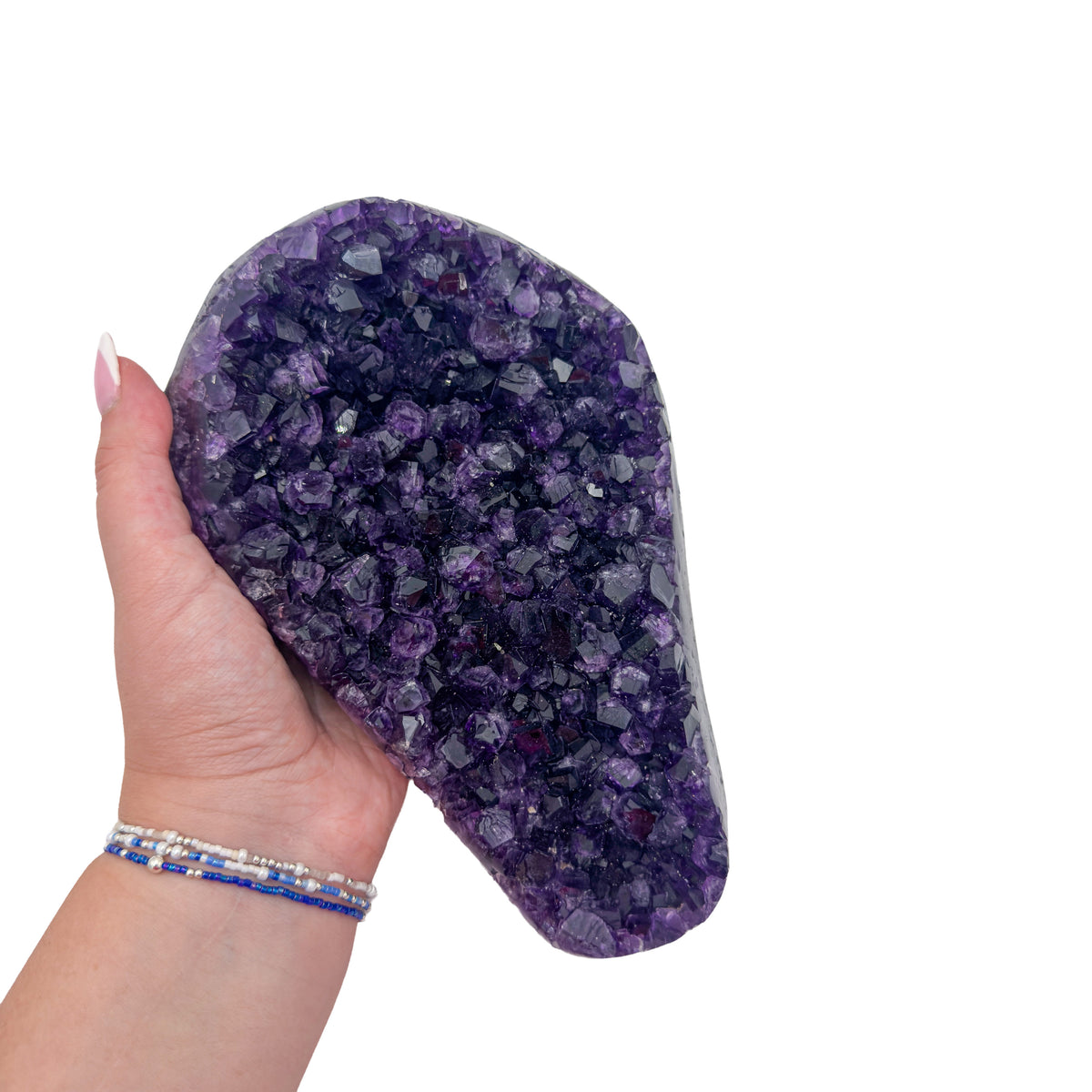 Amethyst polished geode from Uruguay held in an open hand, showing true scale, 3.81 pound tapered wedge, specimen 26.