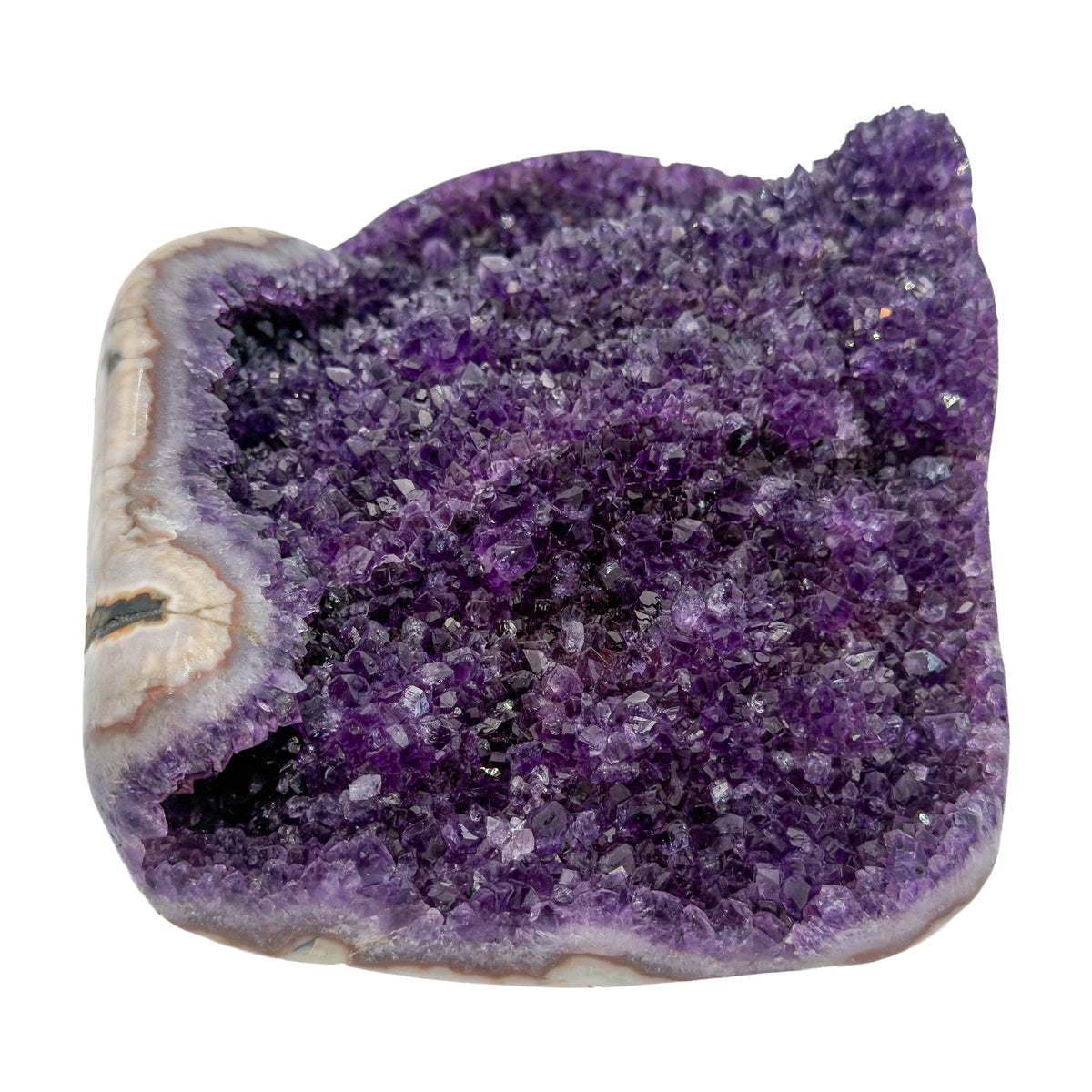 AA grade amethyst geode from Uruguay, left profile, a cream and tan agate rim, specimen 23.
