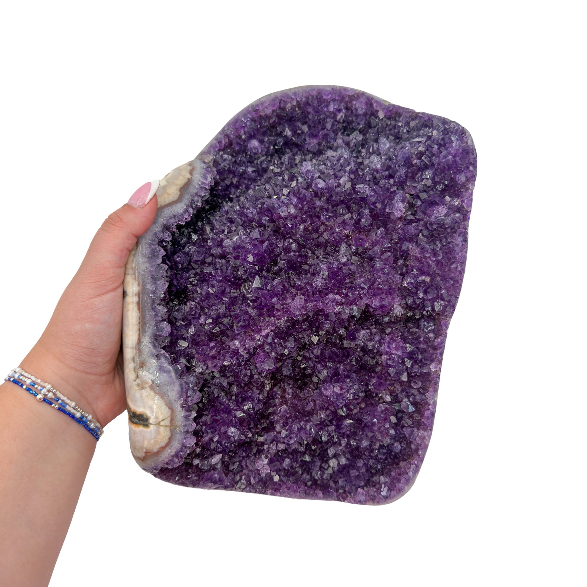 Amethyst polished geode from Uruguay held in an open hand, showing true scale, 7.21 pound wide flat slab, specimen 23.