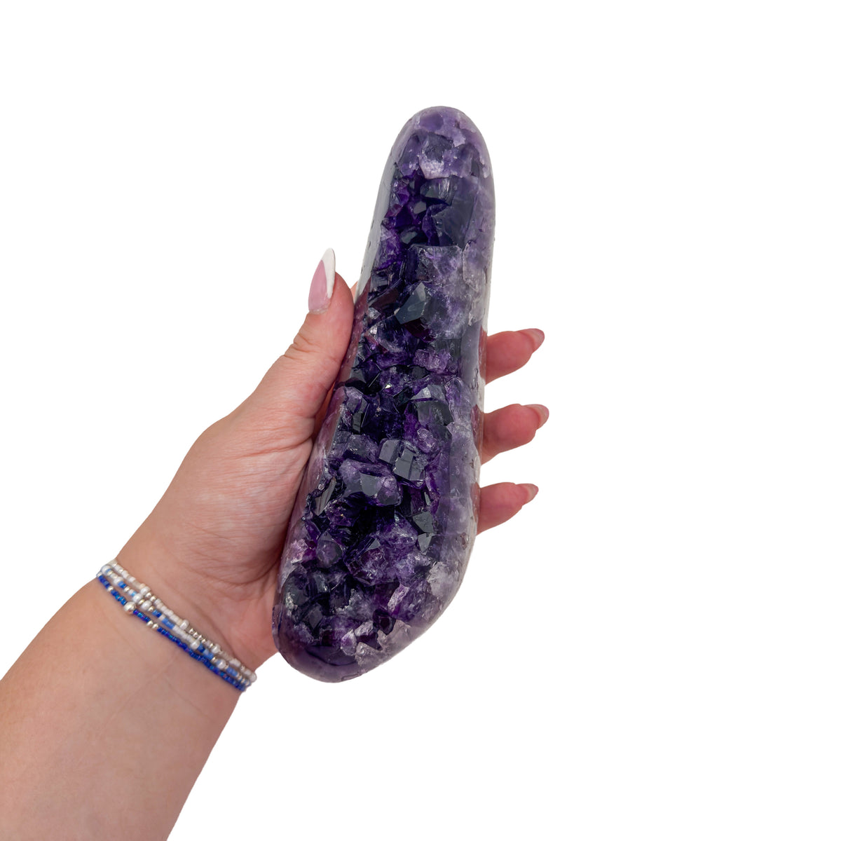 Amethyst polished geode from Uruguay held in an open hand, showing true scale, 2.16 pound long curved crescent section, specimen 6.