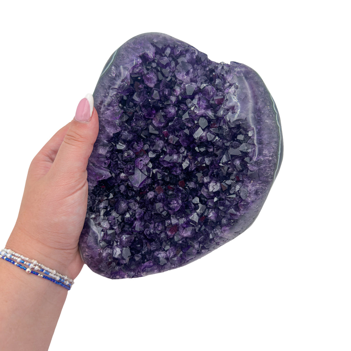 Amethyst polished geode from Uruguay held in an open hand, showing true scale, 5.66 pound rounded shield, specimen 24.