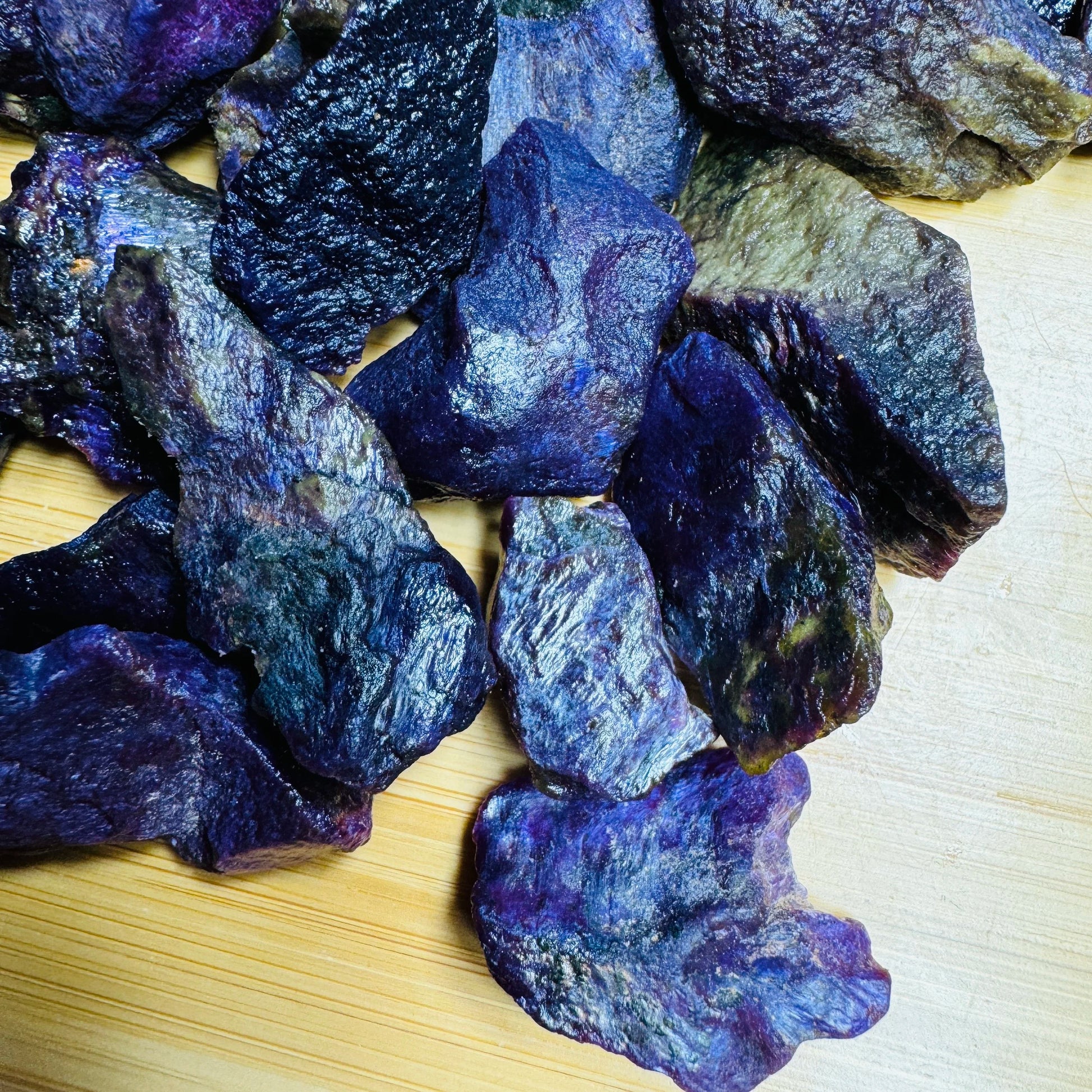 Daylight view of a Stichtite raw stone held against natural backdrop, from Mpumalanga, South Africa.