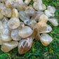 Side angle of clear Quartz tumbled stone, showing soft luster, from Brazil.