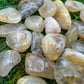 Top-down shot of Quartz tumbled stone, showing natural inclusions.
