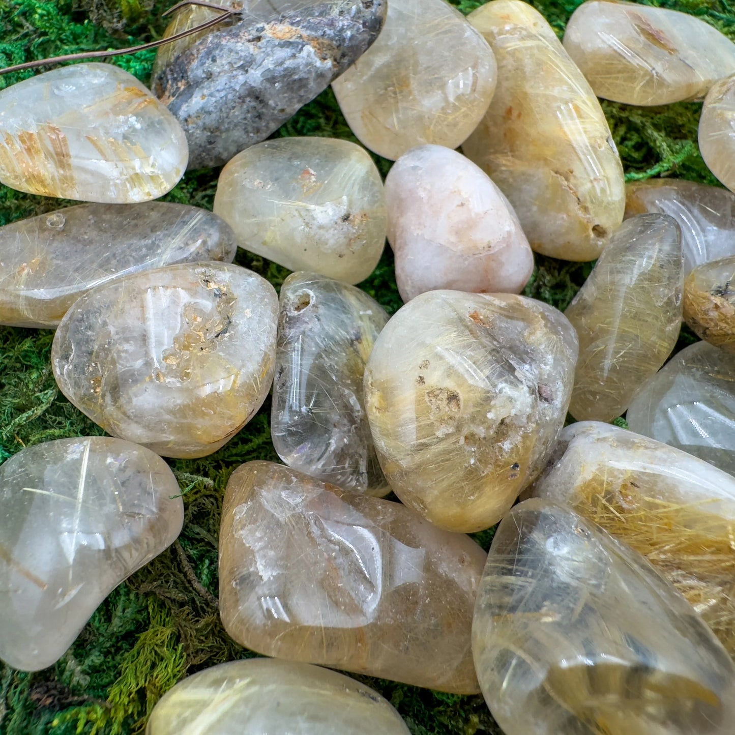 Top-down shot of Quartz tumbled stone, showing natural inclusions.