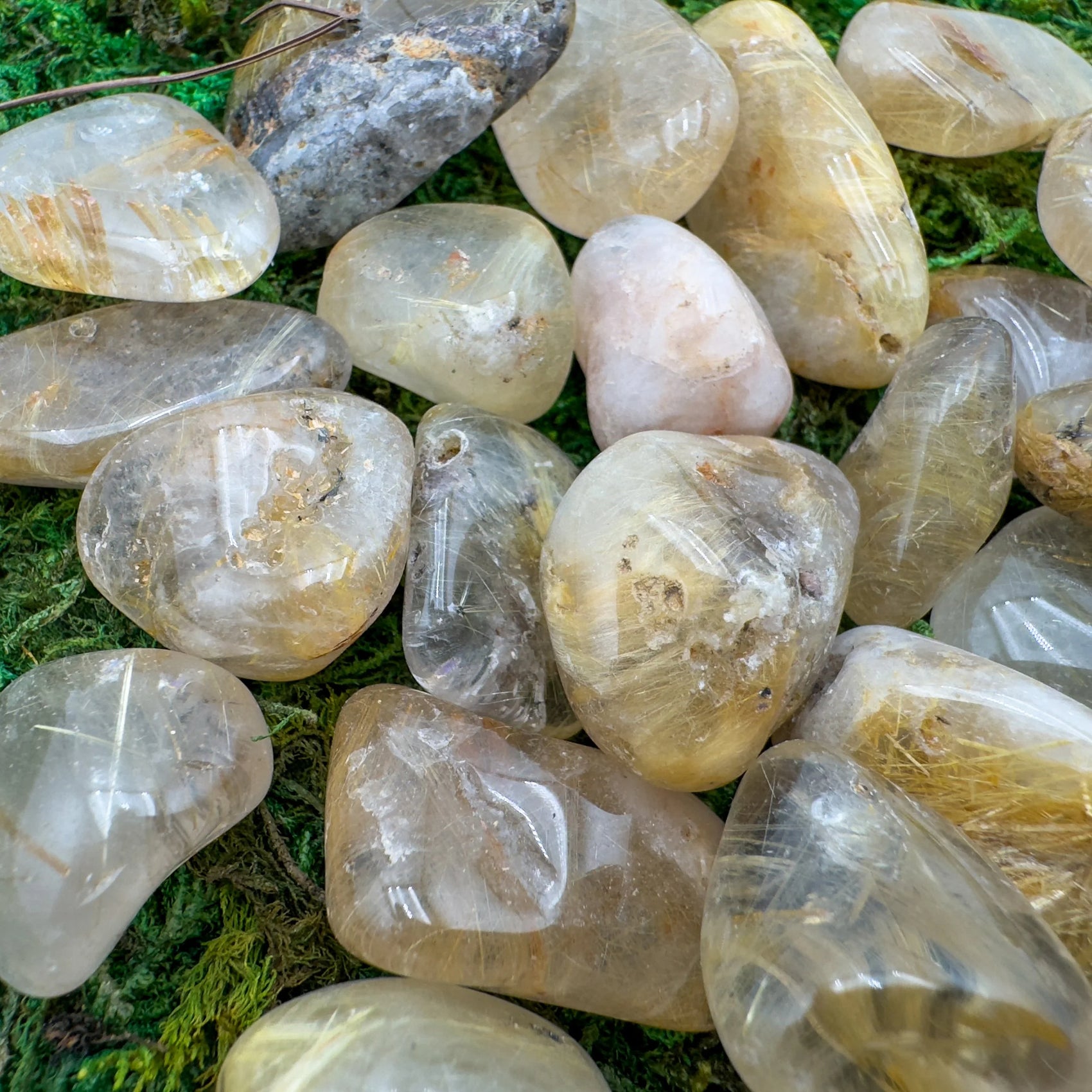 Top-down shot of Quartz tumbled stone, showing natural inclusions.