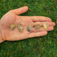 Lifestyle view of a single Quartz tumbled stone sourced from Brazil.