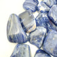 Reverse angle of Sodalite tumbled stone, sourced from Kunene, Namibia, showing characteristic color.