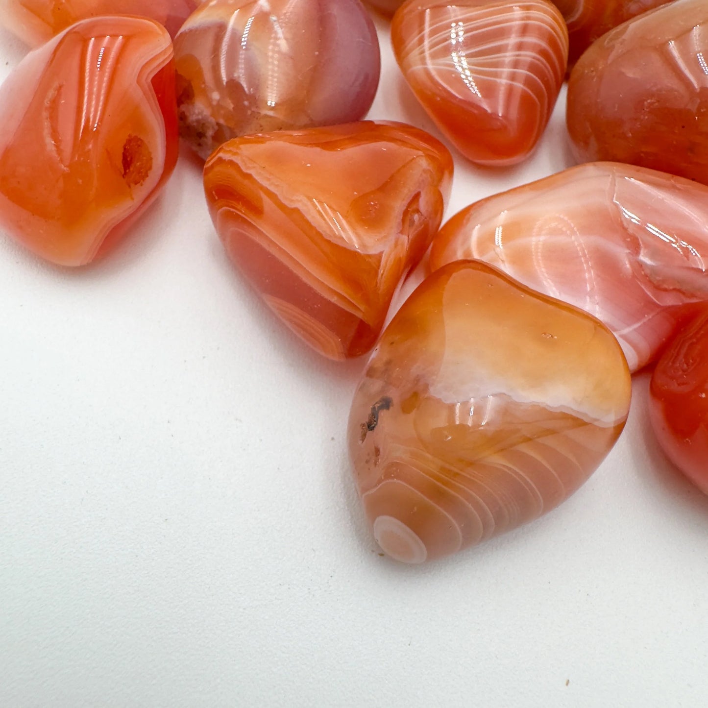 Top view of Grade AA Carnelian tumbled stone, sourced from Francistown, Botswana