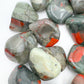 Underside detail of Grade AA Bloodstone tumbled stone, showing translucent edges.