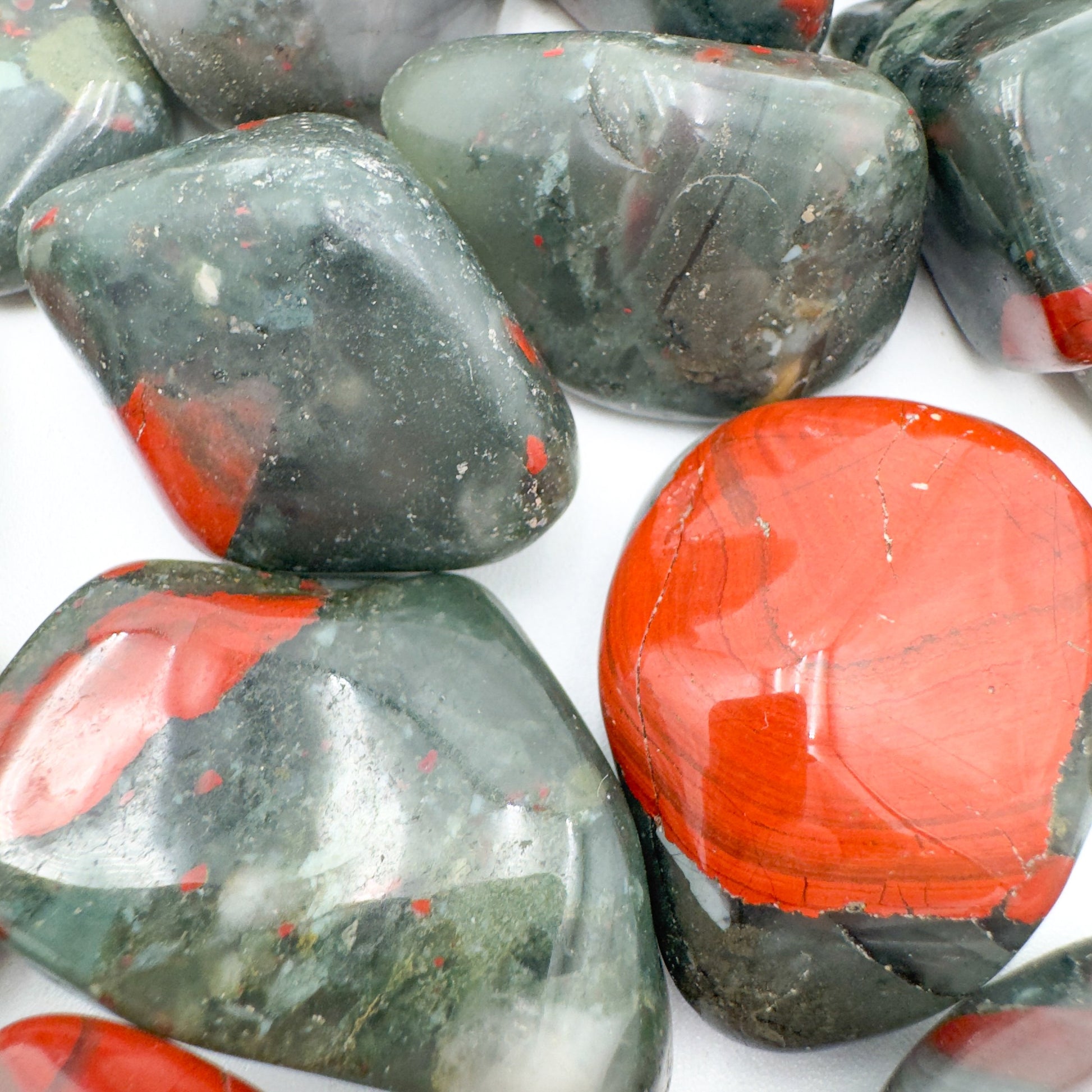 Scale reference of a single Bloodstone tumbled stone sourced from Eswatini.