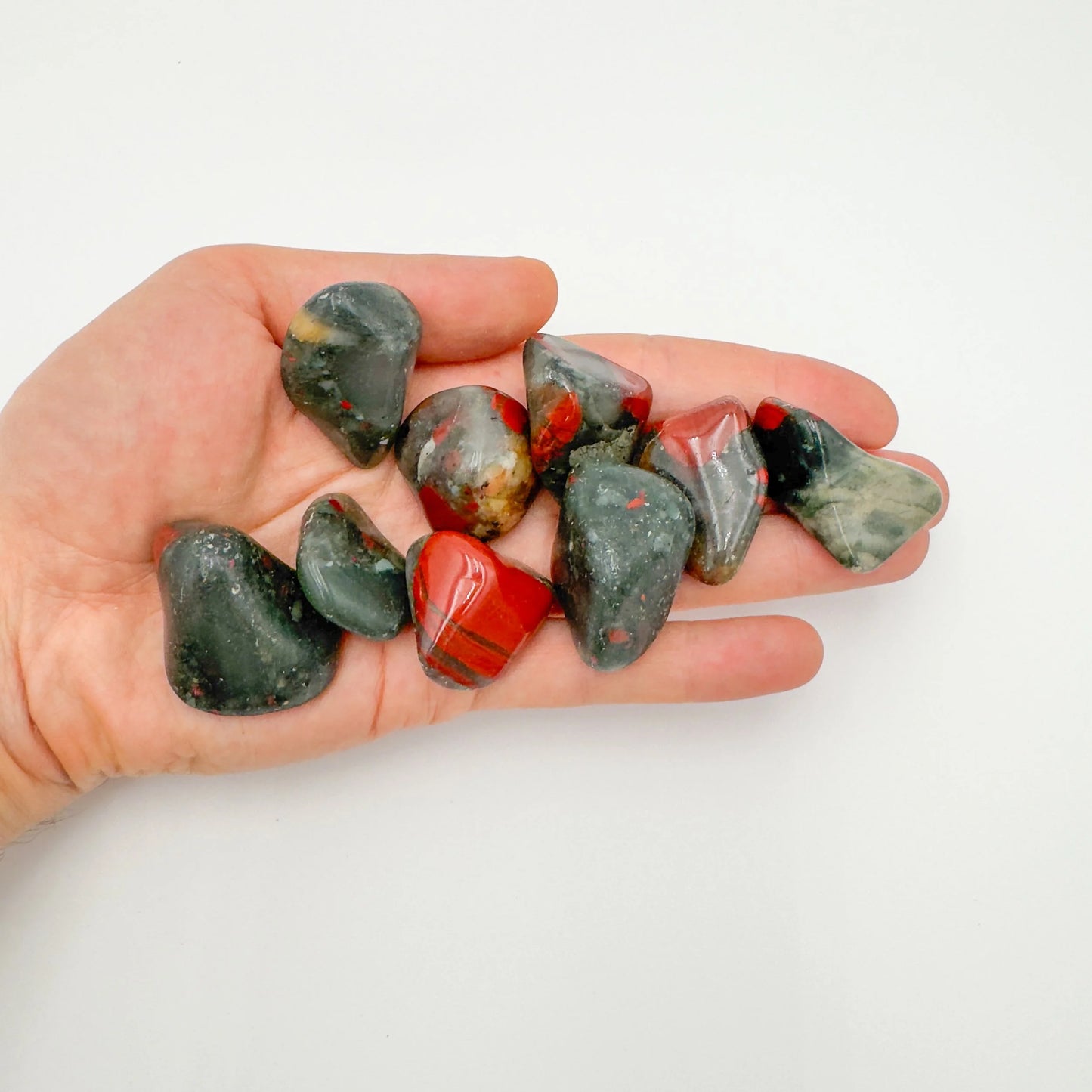 Detail shot of Grade AA Bloodstone tumbled stone under natural light