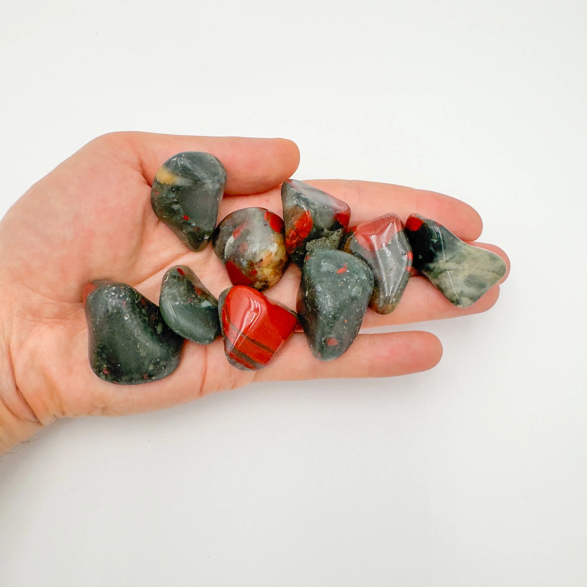 Detail shot of Grade AA Bloodstone tumbled stone under natural light