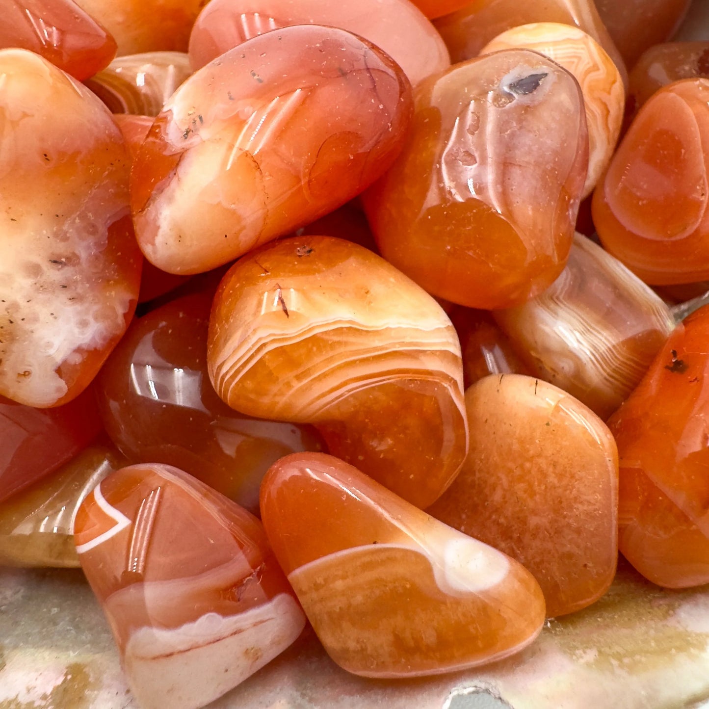 Alternate angle of Grade AA Carnelian tumbled stone showing overall shape