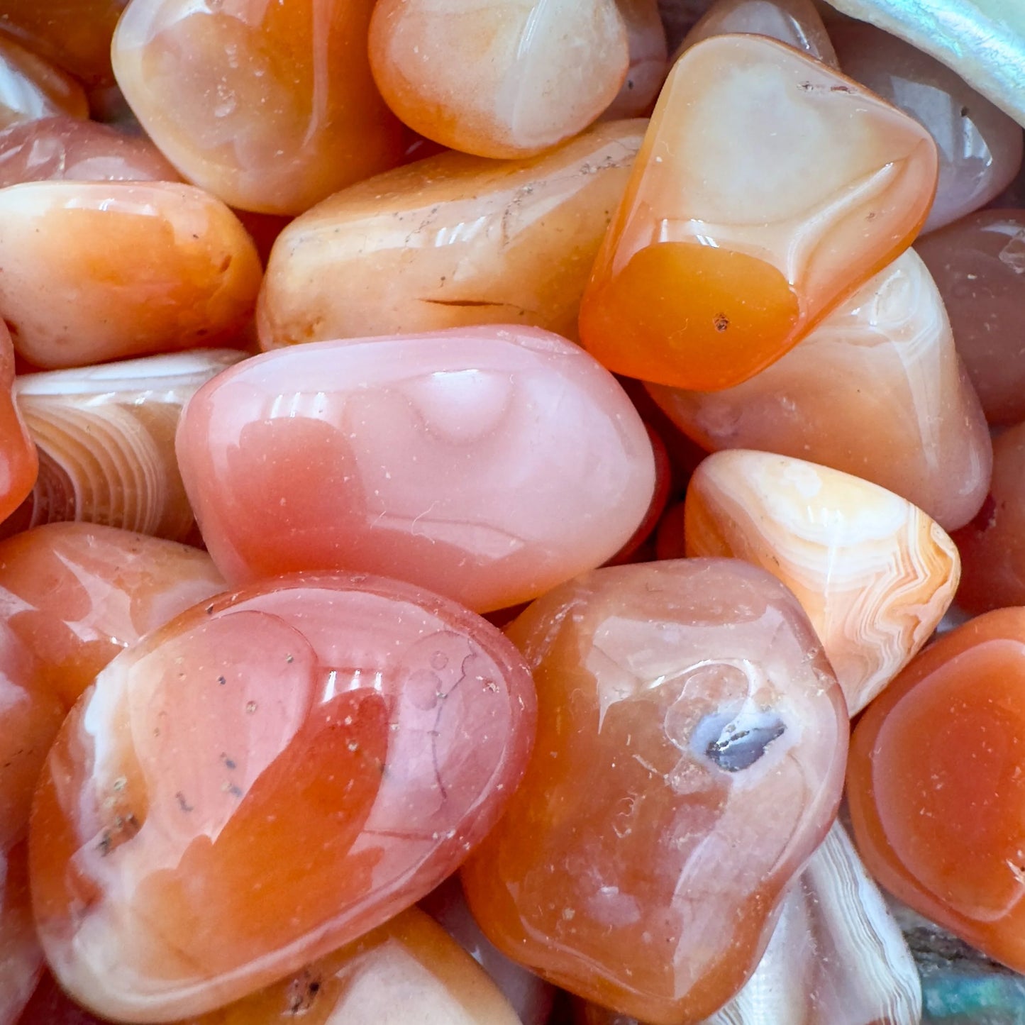 Top view of Grade AA Carnelian tumbled stone, sourced from Francistown, Botswana
