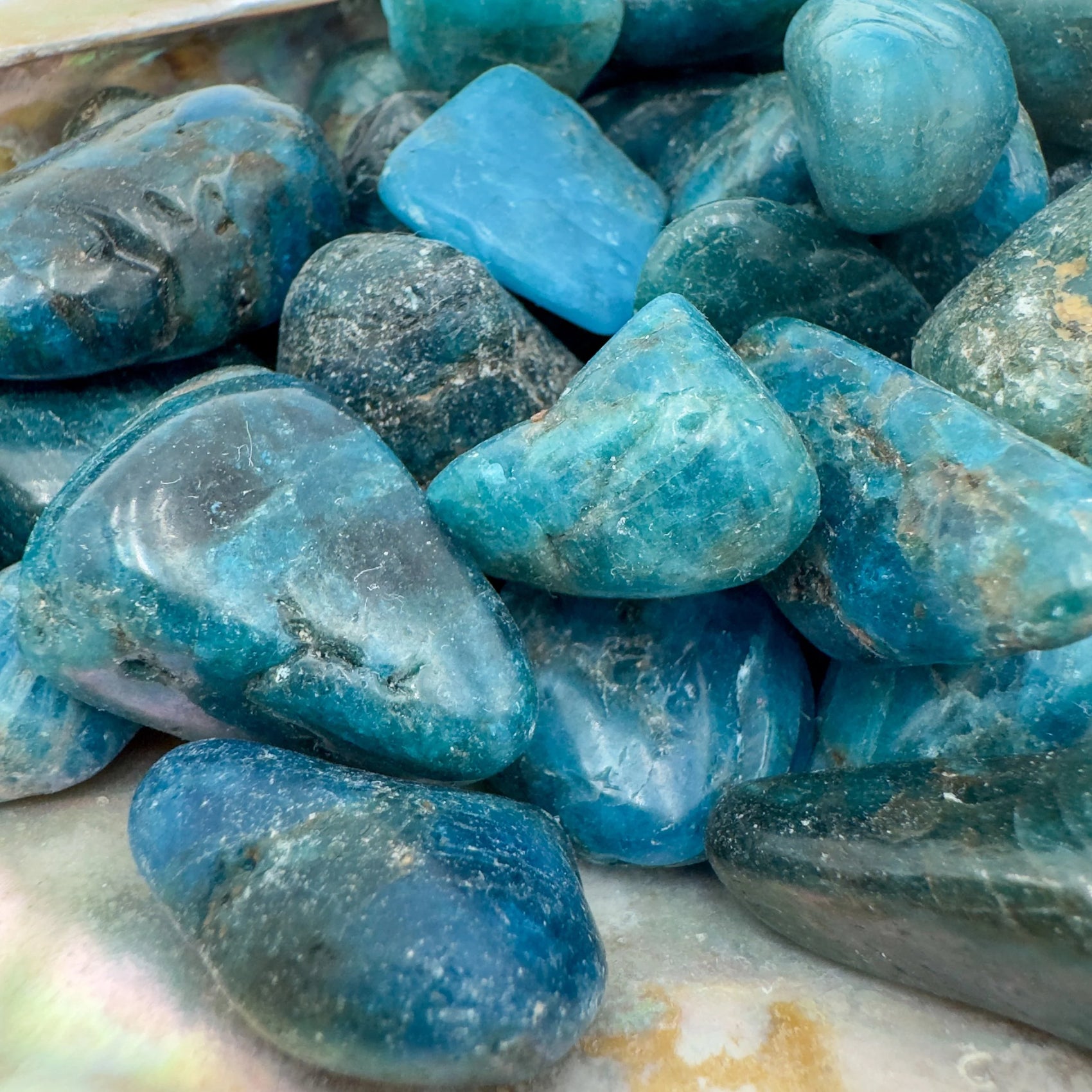 Profile view of Apatite tumbled stone, Madagascar-sourced, often kept for Focus and Manifestation.