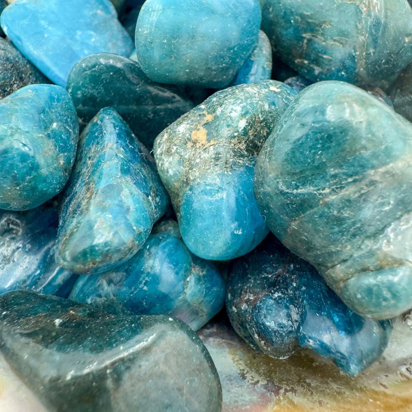 Looking down on Grade AA blue Apatite tumbled stone, worked with for Focus.