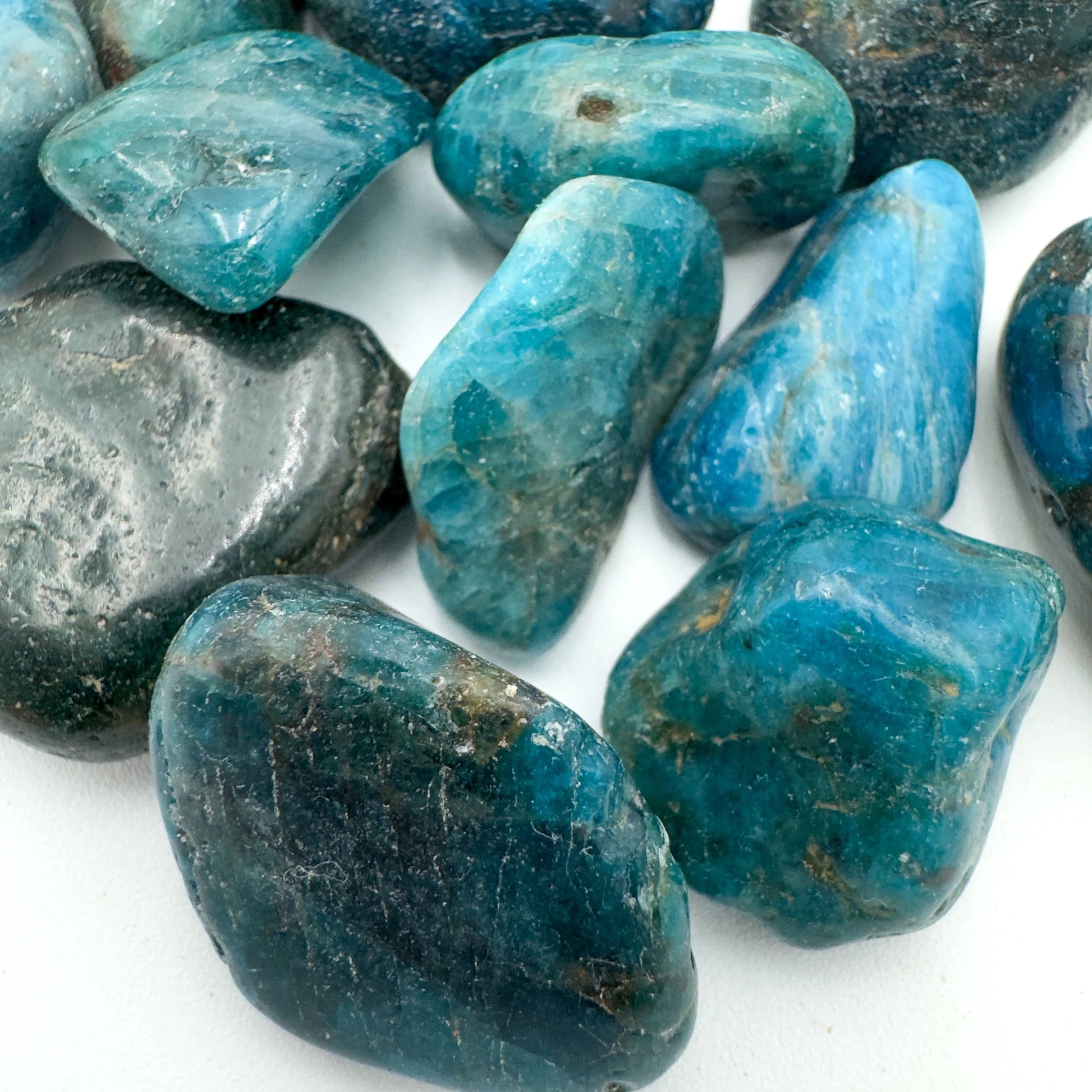 Hand-held view of a Apatite tumbled stone to support Focus, sourced from Anosy, Madagascar.
