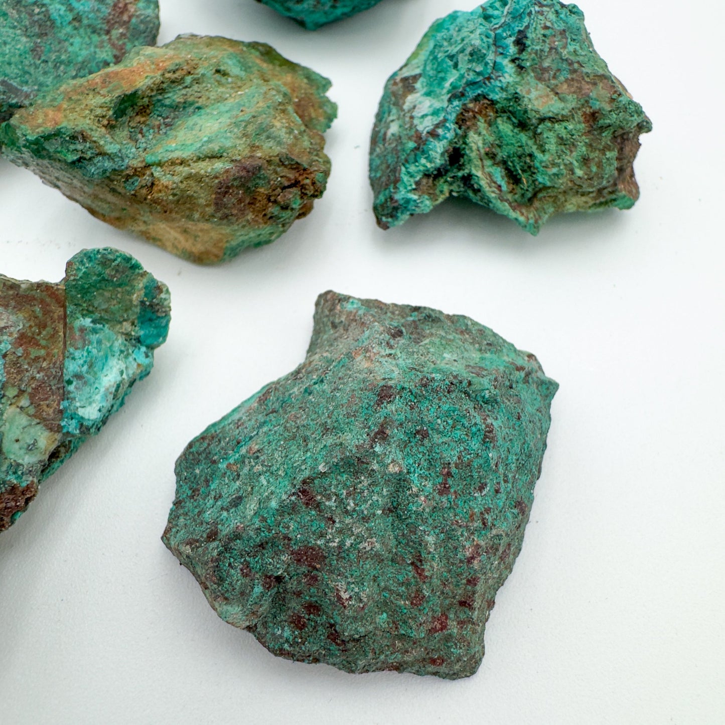 Edge-on view of Chrysocolla raw stone, showing natural sheen.