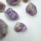 Top-down shot of Grade A Amethyst raw stone, showing subtle veining.