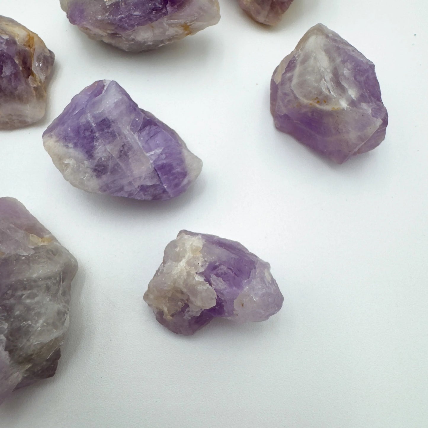Top-down shot of Grade A Amethyst raw stone, showing subtle veining.