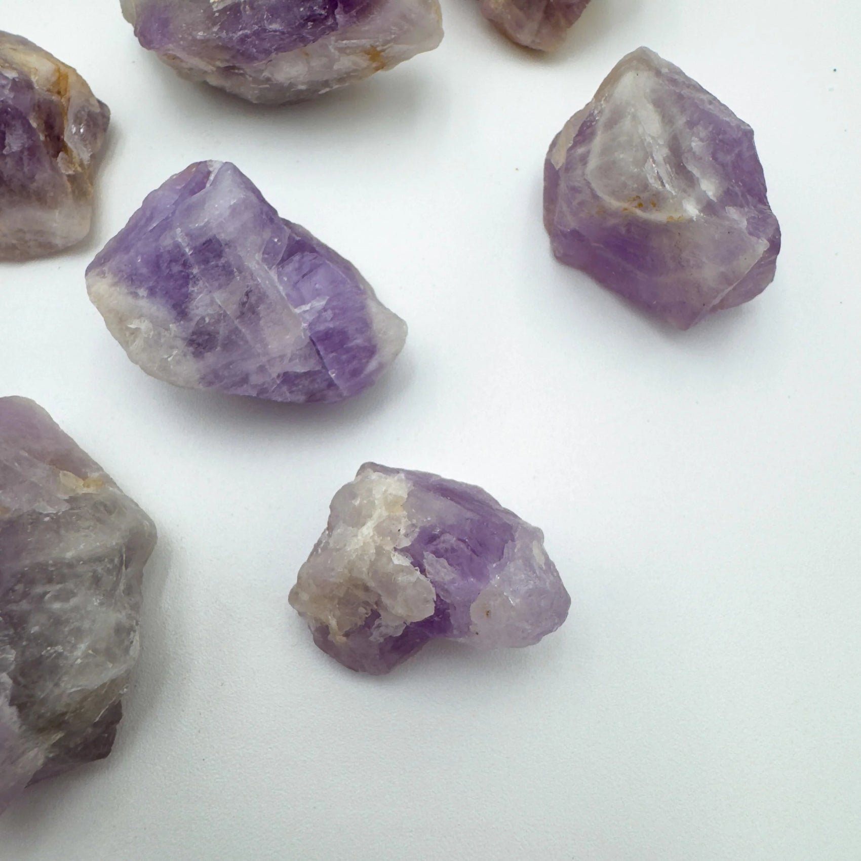 Top-down shot of Grade A Amethyst raw stone, showing subtle veining.