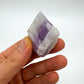 Grade a amethyst raw held in hand for size reference
