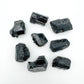 Profile view of Black Tourmaline raw stone, linked to Protection and Grounding.