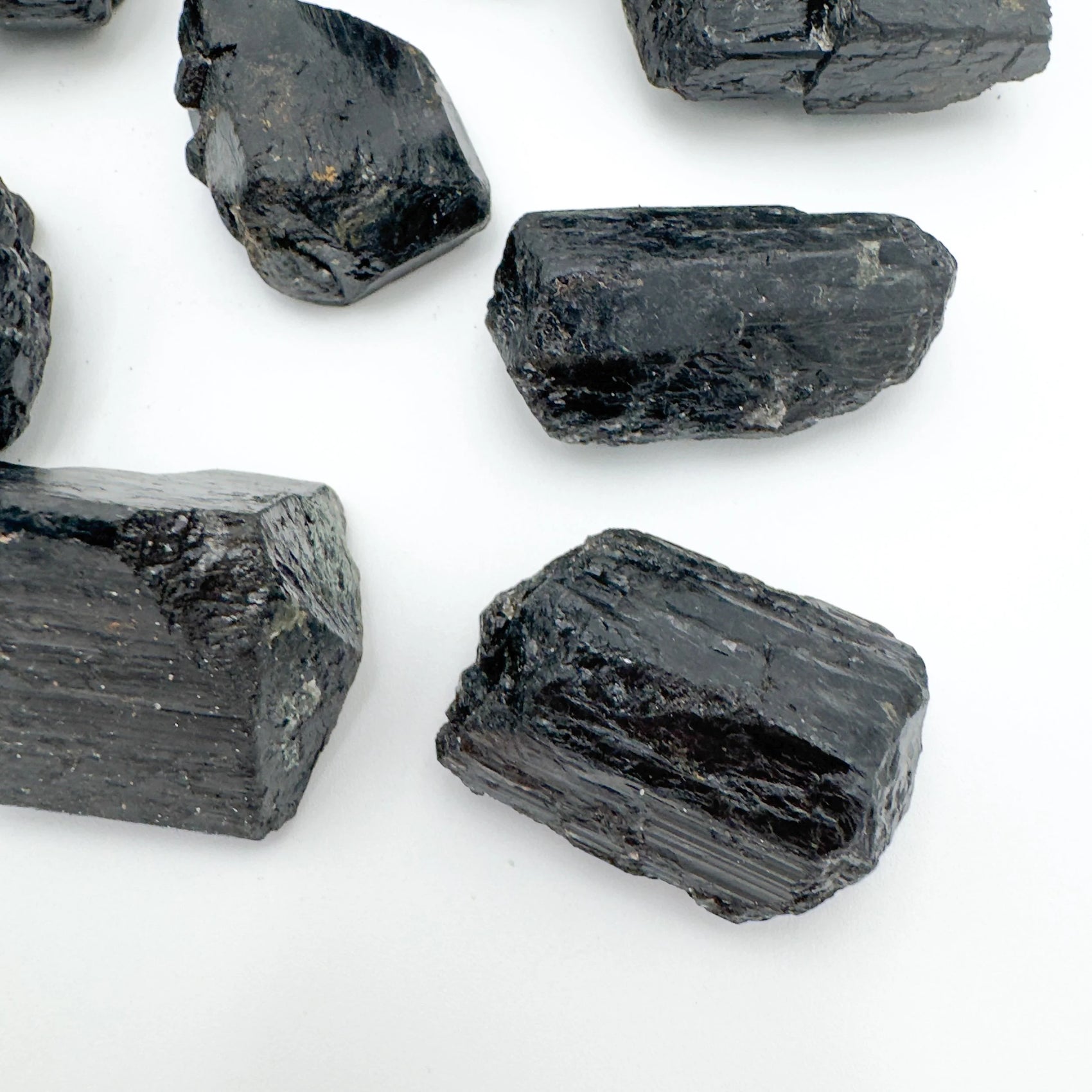 Back view of Grade AA Black Tourmaline raw stone, showing natural form, sourced from Vakinankaratra, Madagascar.