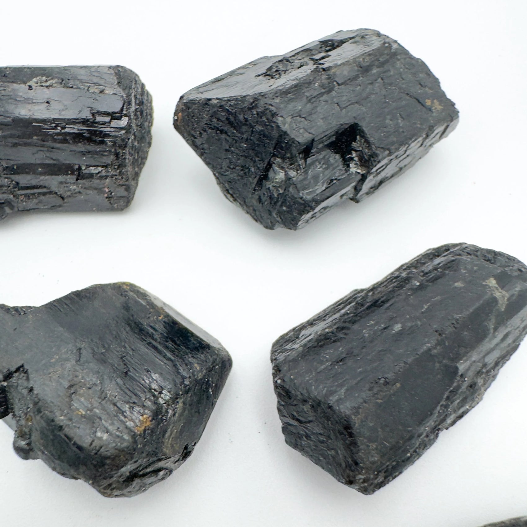 Alternate angle of Grade AA Black Tourmaline raw showing overall shape