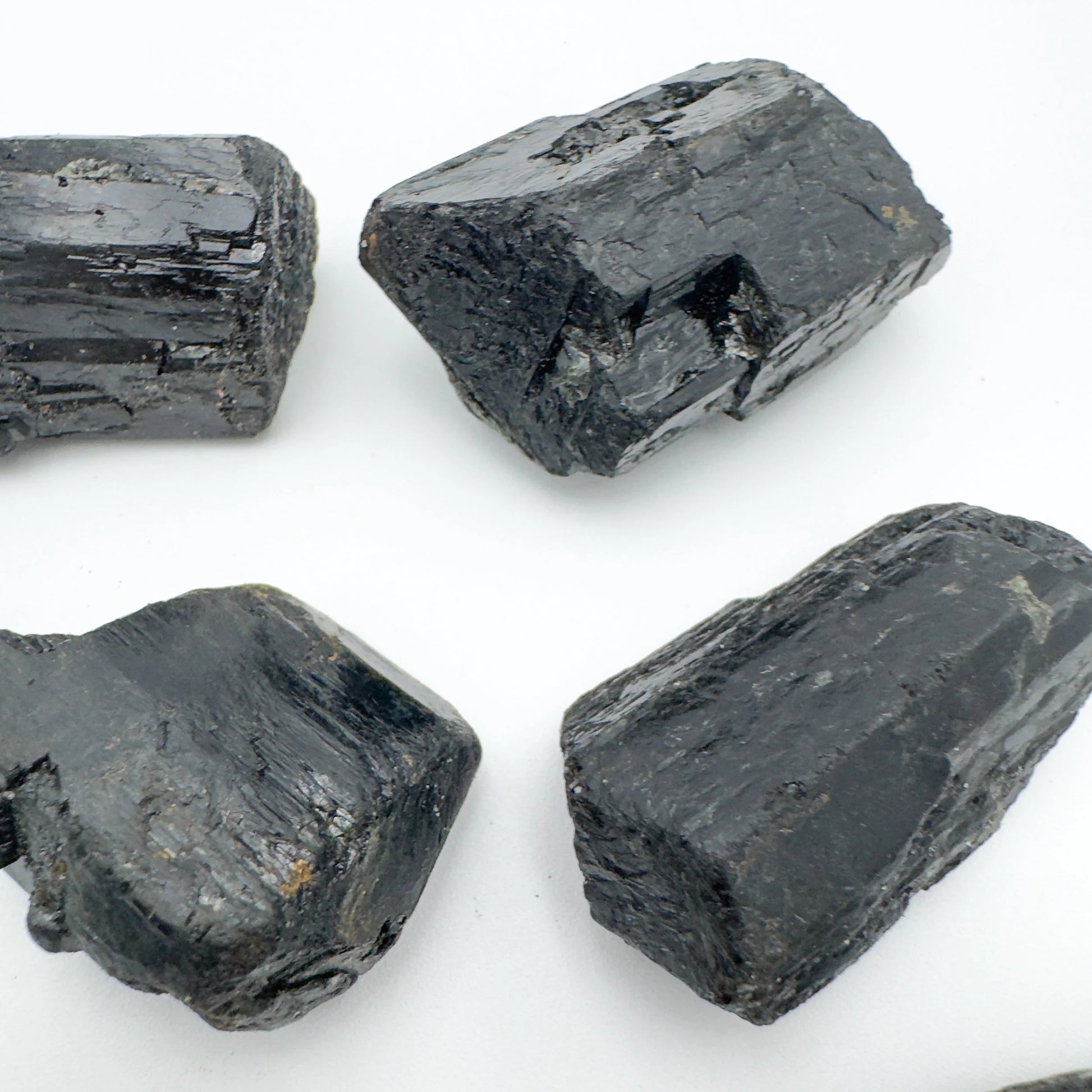 Alternate angle of Grade AA Black Tourmaline raw showing overall shape