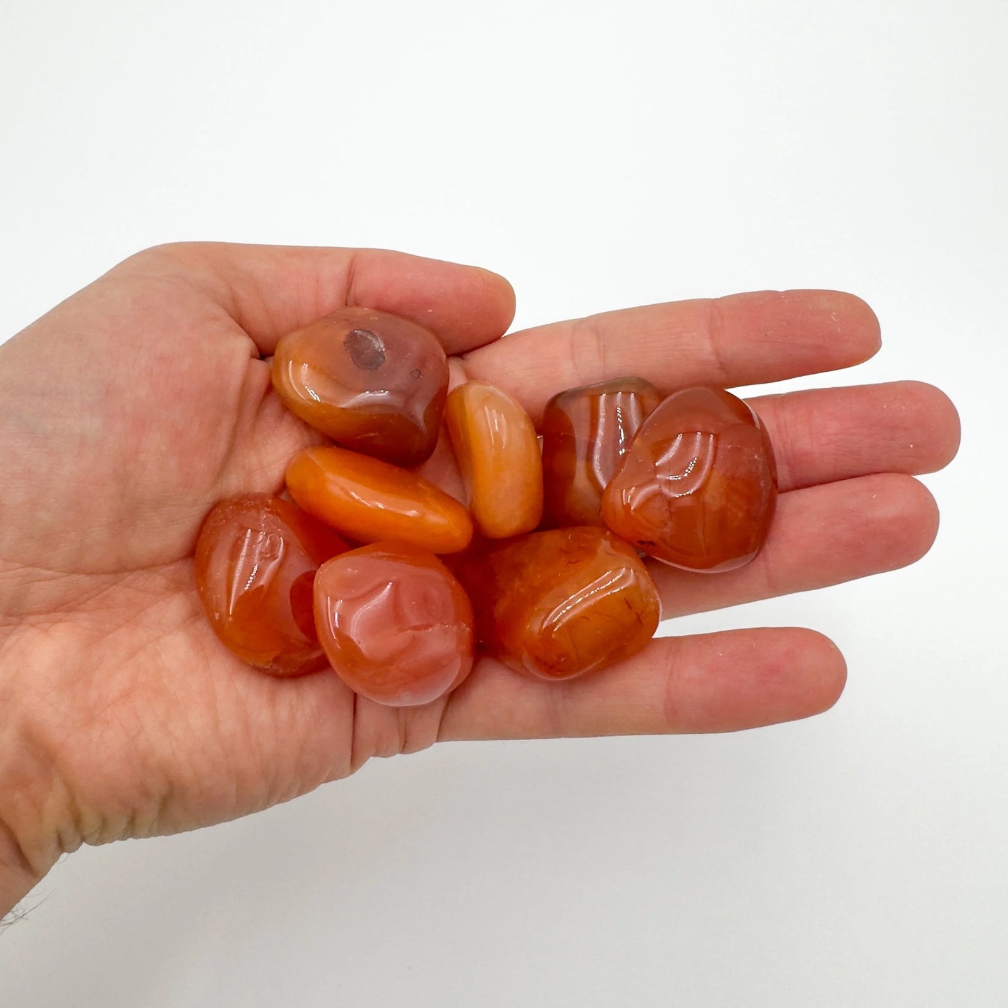 Top view of Grade AA Carnelian tumbled stone, sourced from Francistown, Botswana