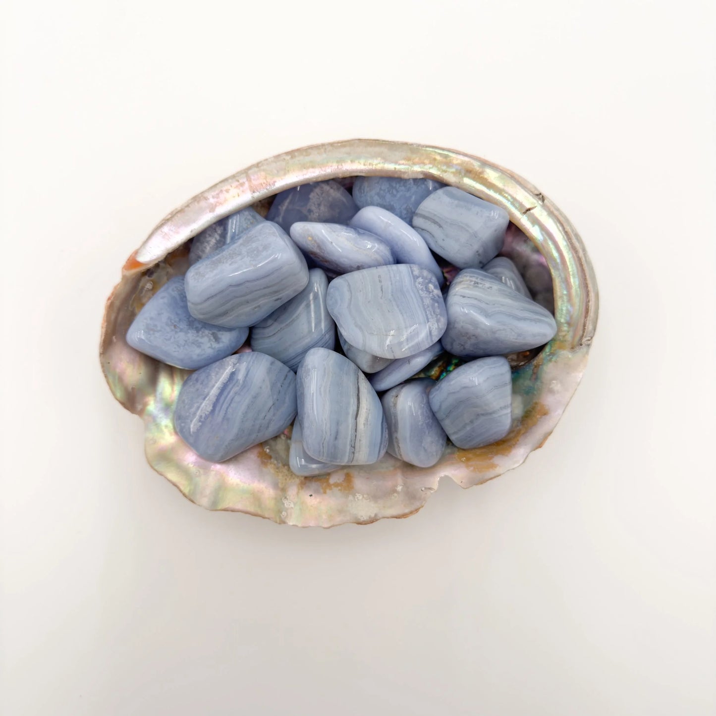 Detail capture of Grade A Blue Lace Agate tumbled stone, kept close for Stress Relief and Emotional Healing, Namibia-sourced.