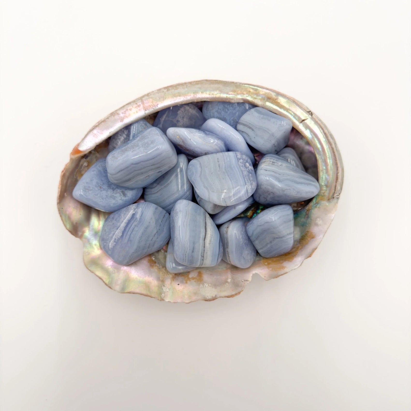 Detail capture of Grade A Blue Lace Agate tumbled stone, kept close for Stress Relief and Emotional Healing, Namibia-sourced.
