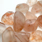 Back view of Fire Quartz tumbled stone, hand-selected from Alaotra-Mangoro, Madagascar, kept close for Grounding and Confidence.