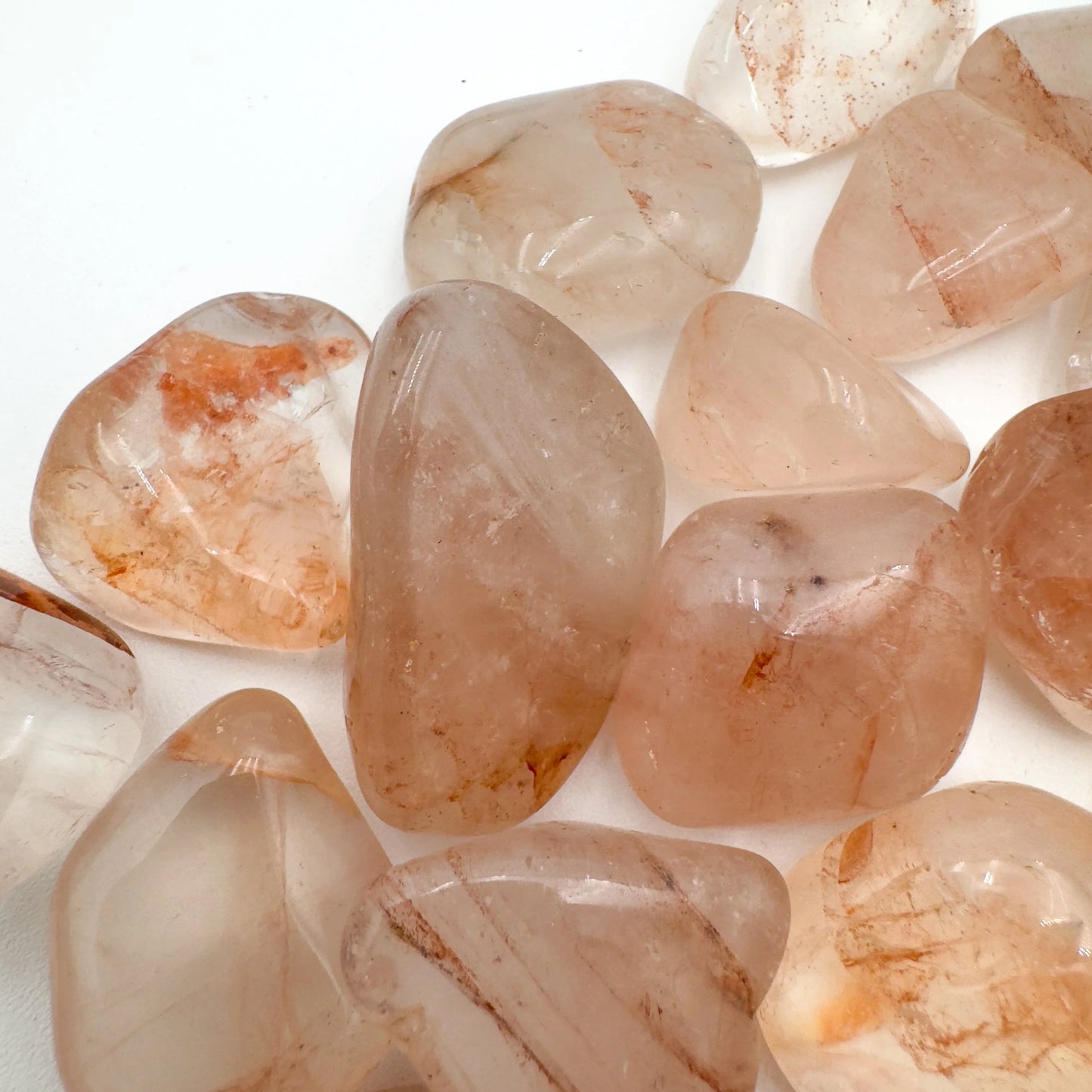 Back view of Fire Quartz tumbled stone, hand-selected from Alaotra-Mangoro, Madagascar, kept close for Grounding and Confidence.