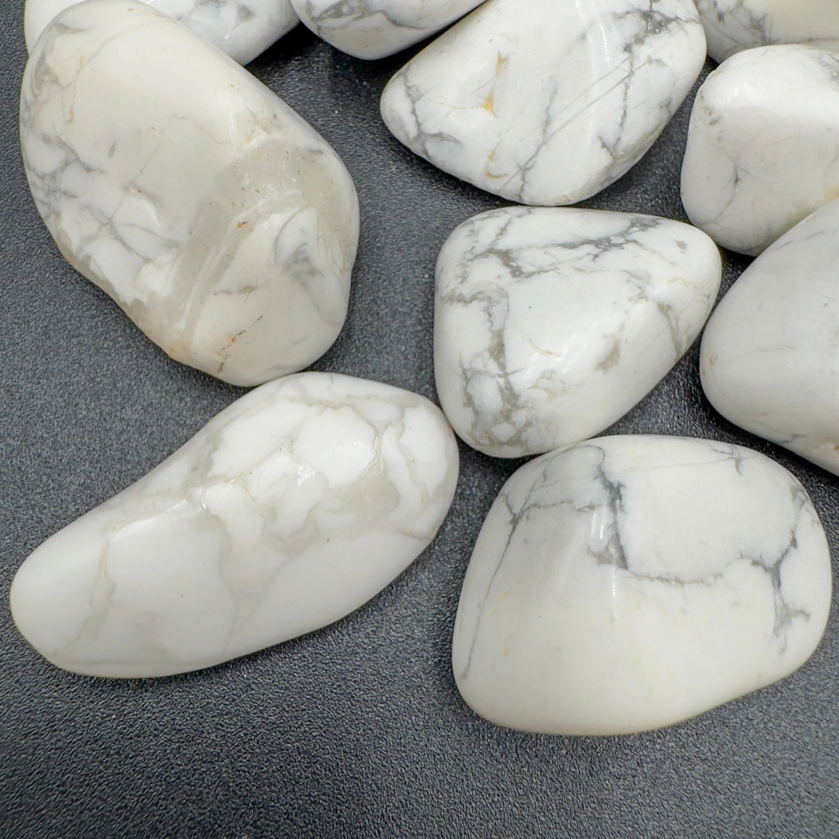 Side profile of Howlite tumbled stone, hand-selected from Masvingo, Zimbabwe, to support Stress Relief.