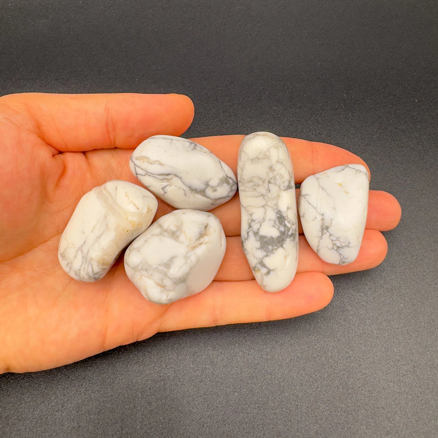 Held in palm of a Howlite tumbled stone, from Masvingo, Zimbabwe, associated with Meditation, with character of the piece on display.