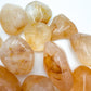 Palm-scale view of a Golden Healer tumbled stone, from Madagascar.