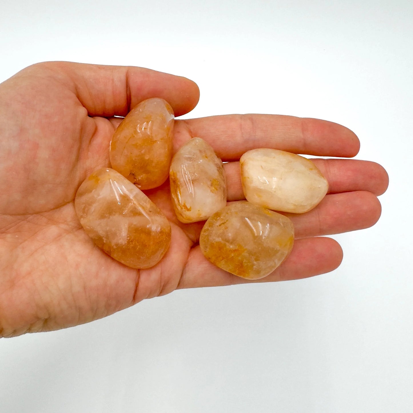 Open-palm view of Golden Healer tumbled stone, from Alaotra-Mangoro, Madagascar, associated with Healing, showing natural surface character.