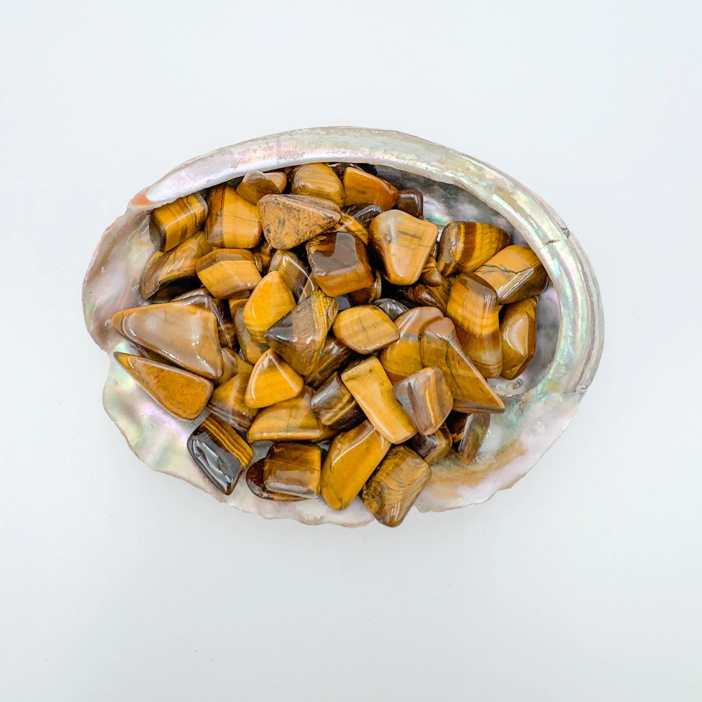 Detail capture of Grade A Tiger Eye tumbled stone, traditionally used for Confidence and Career, South Africa-sourced.