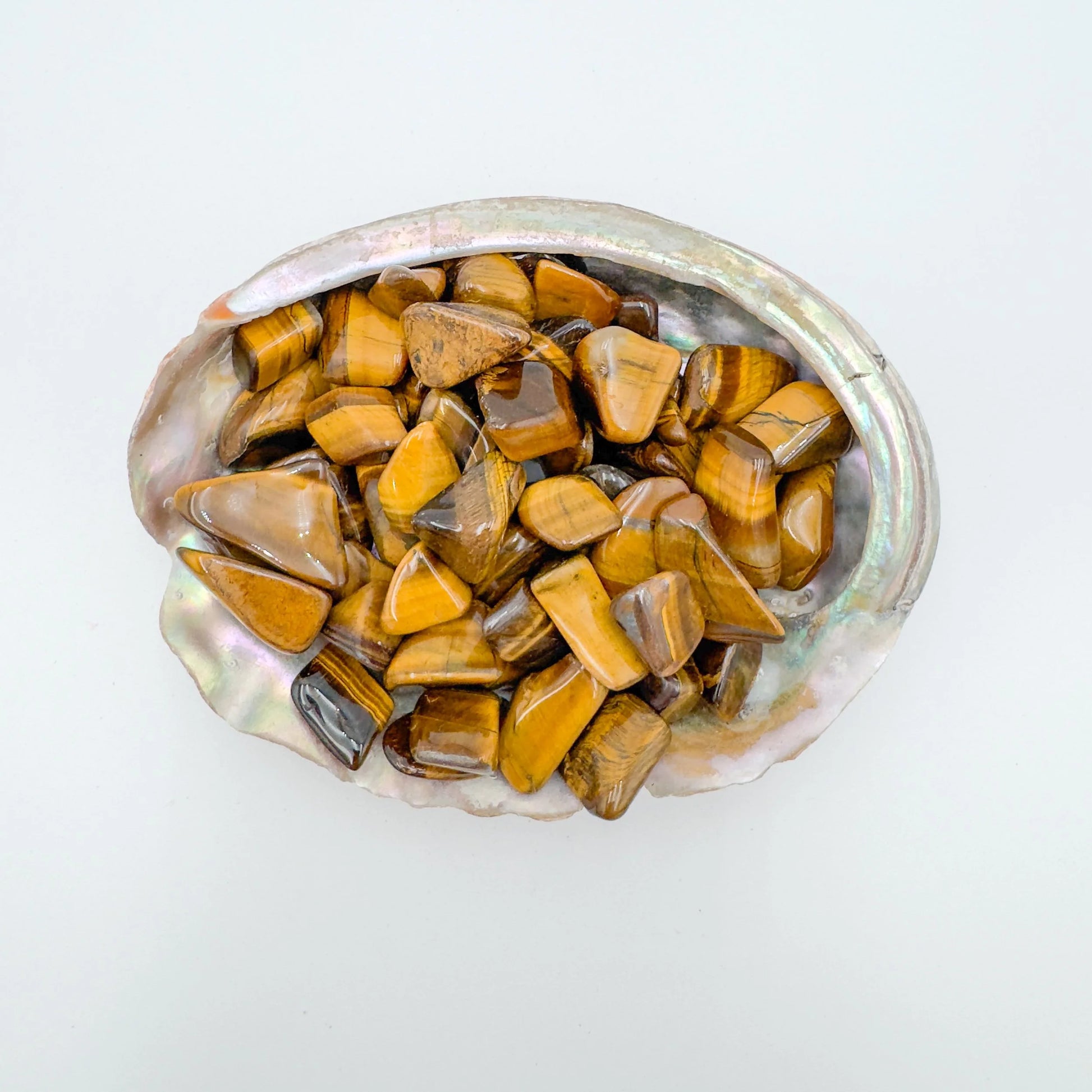 Detail capture of Grade A Tiger Eye tumbled stone, traditionally used for Confidence and Career, South Africa-sourced.