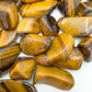 Profile shot of Tiger Eye tumbled stone, showing natural sheen.