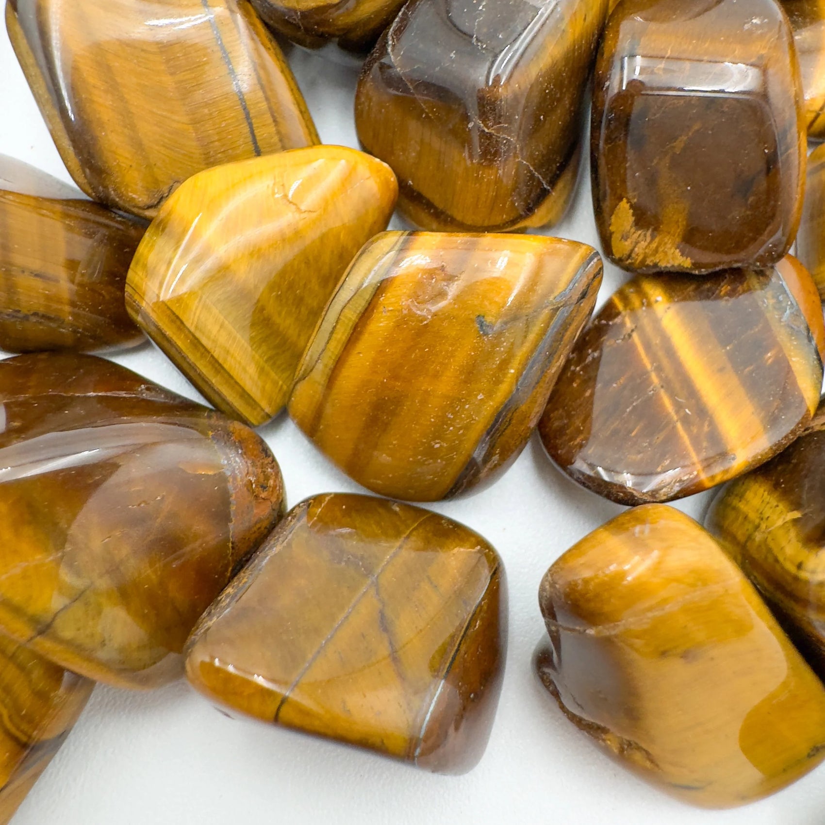 Looking down on Tiger Eye tumbled stone, associated with Confidence and Career, sourced from Northern Cape, South Africa.